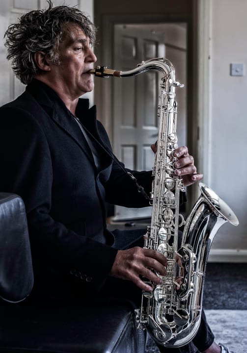 Portrait or photograph of Adolphe Sax: Raphael Ravenscroft playing on an Adolphe Sax & Cie tenor saxophone . This was the last project he was involved in.