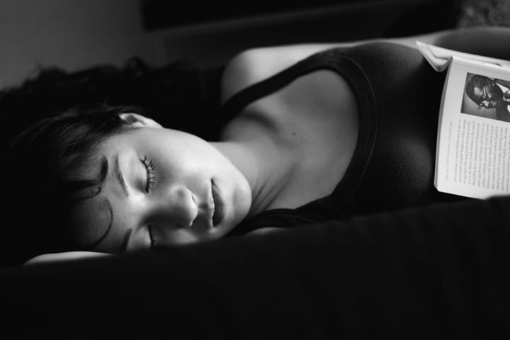 Portrait or photograph of Aime Cesaire: Black & Withe photograph of Jackie Martinez in B&W sleeping with a book of Aime Cesaire Mark J. Sebastian | www.