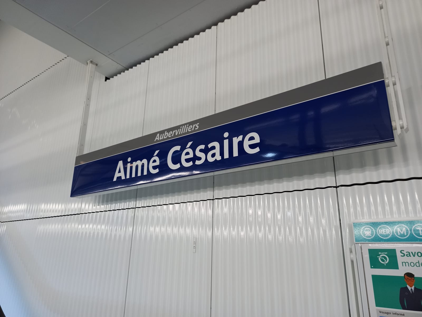 Portrait or photograph of Aime Cesaire: The station sign for the new Aimé Césaire station, taken on its opening day (2022-05-31).