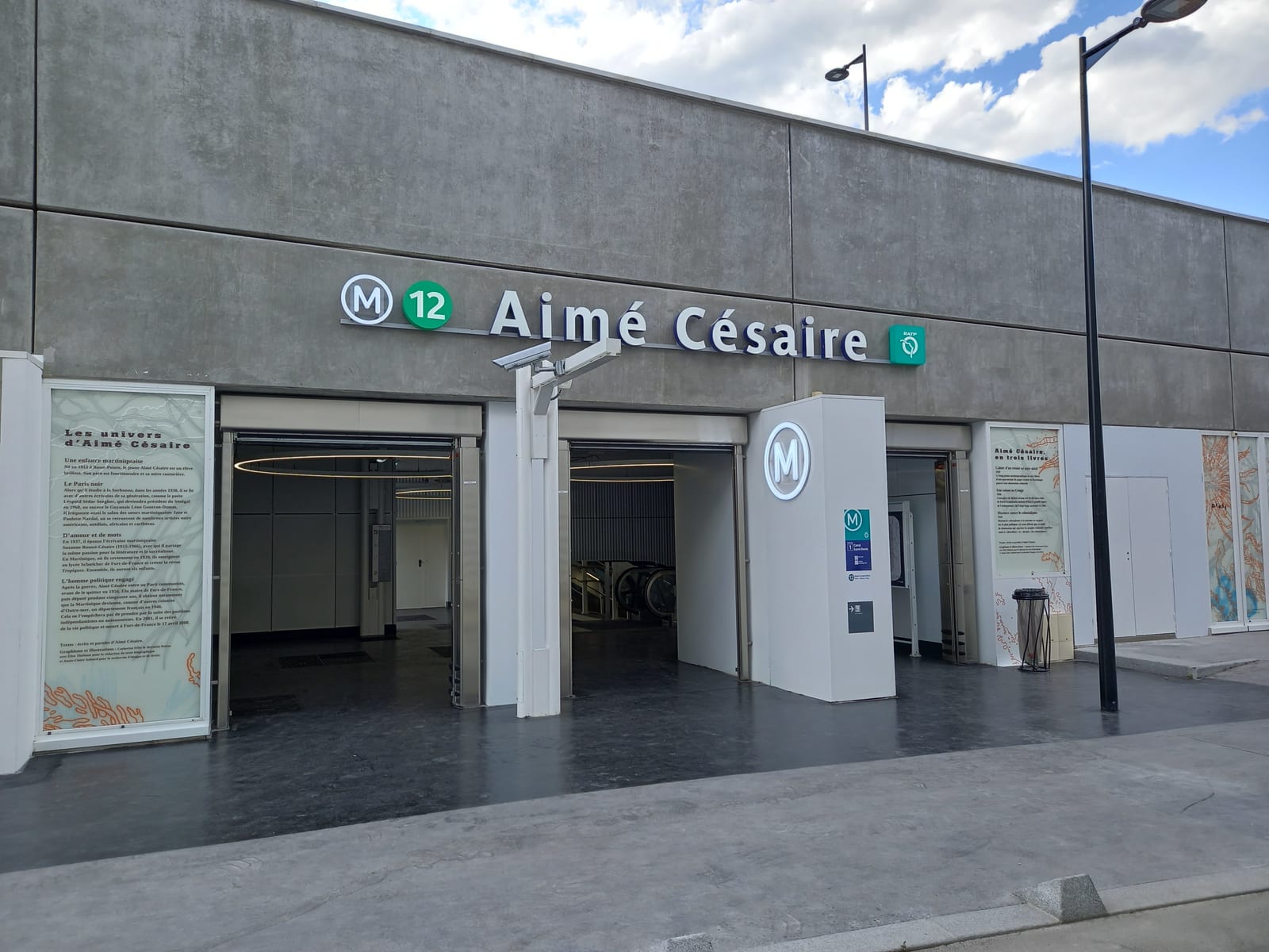 Portrait or photograph of Aime Cesaire: One of the three station entrances of the new Aimé Césaire station on its opening day (2022-05-31).