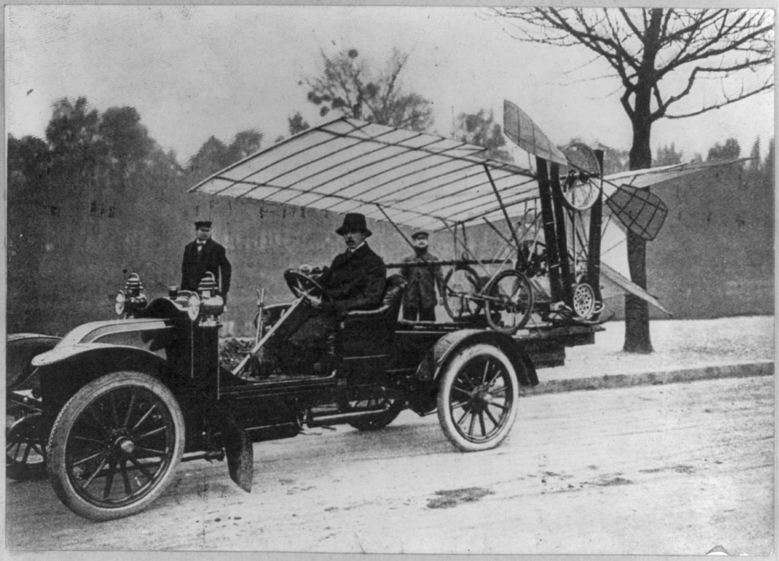 Portrait or photograph of Alberto Santos-Dumont: Title: Alberto Santos-Dumont taking his Demoisille monoplane out to the practice grounds for a flight, 1909 Abs