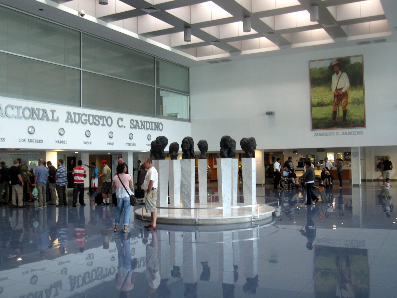 Portrait or photograph of Augusto Cesar Sandino: Main hall of Augusto C. Sandino international airport right before the security checkpoint, with sculptures in