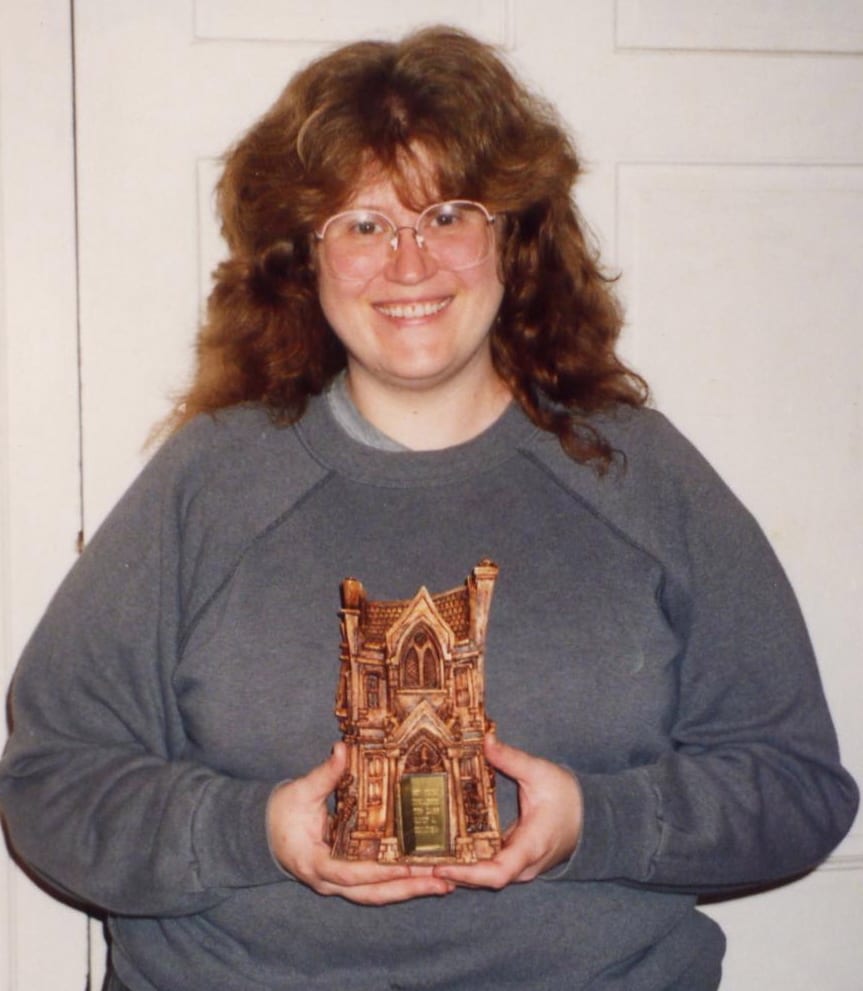Portrait or photograph of Bram Stoker: Writer Nancy A. Collins poses with the "Bram Stoker Award" she won in 1988 for Sunglasses After Dark .
