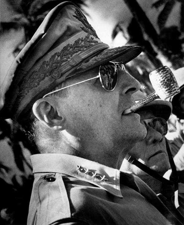 Portrait or photograph of Douglas MacArthur: General Douglas MacArthur surveys the beachhead on Leyte Island , soon after American forces swept ashore from a gi