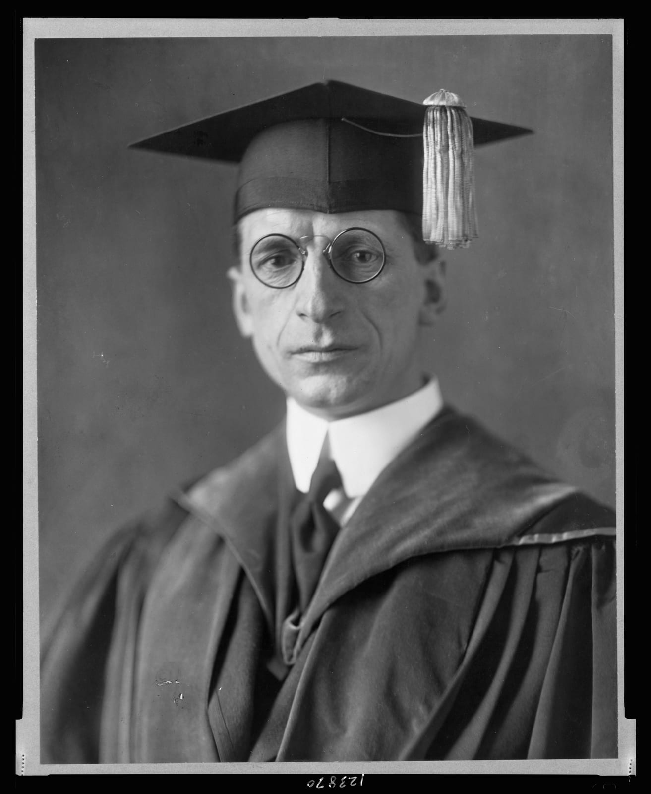 Portrait or photograph of Eamon de Valera: Title: Eamon De Valera, head-and-shoulders portrait, facing front, wearing cap and gown Abstract/medium: 1 photograph