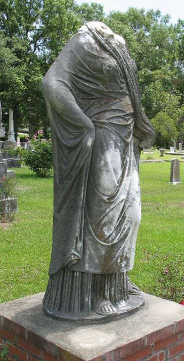 Portrait or photograph of Eudora Welty: Eudora Welty took a picture of this monument in the late '30s. At that time the woman was holding a book and her hair wa