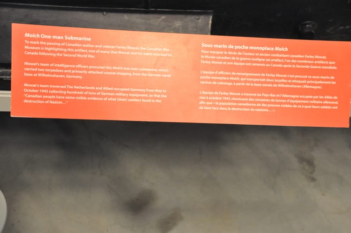 Portrait or photograph of Farley Mowat: An interesting sign near the Molch Midget one man submarine stating that the exhibit is being highlighted to commemorate