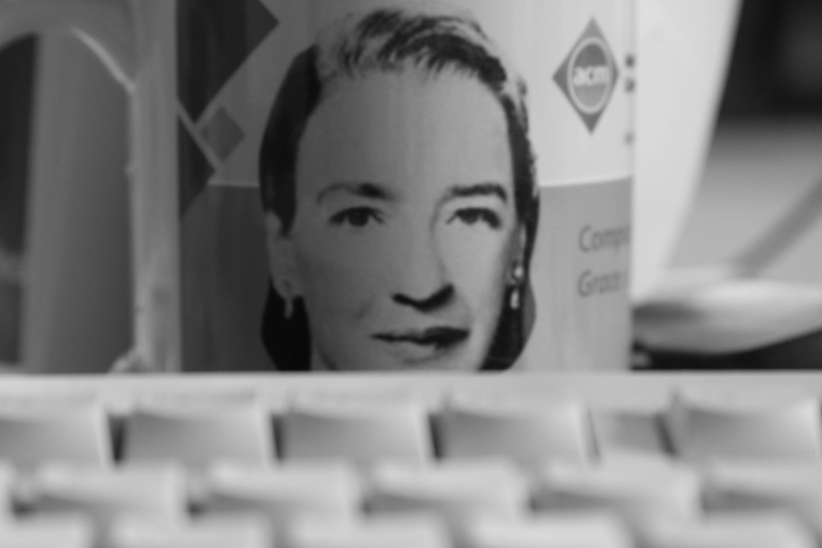 Portrait or photograph of Grace Hopper: Grace Hopper mug and a keyboard
