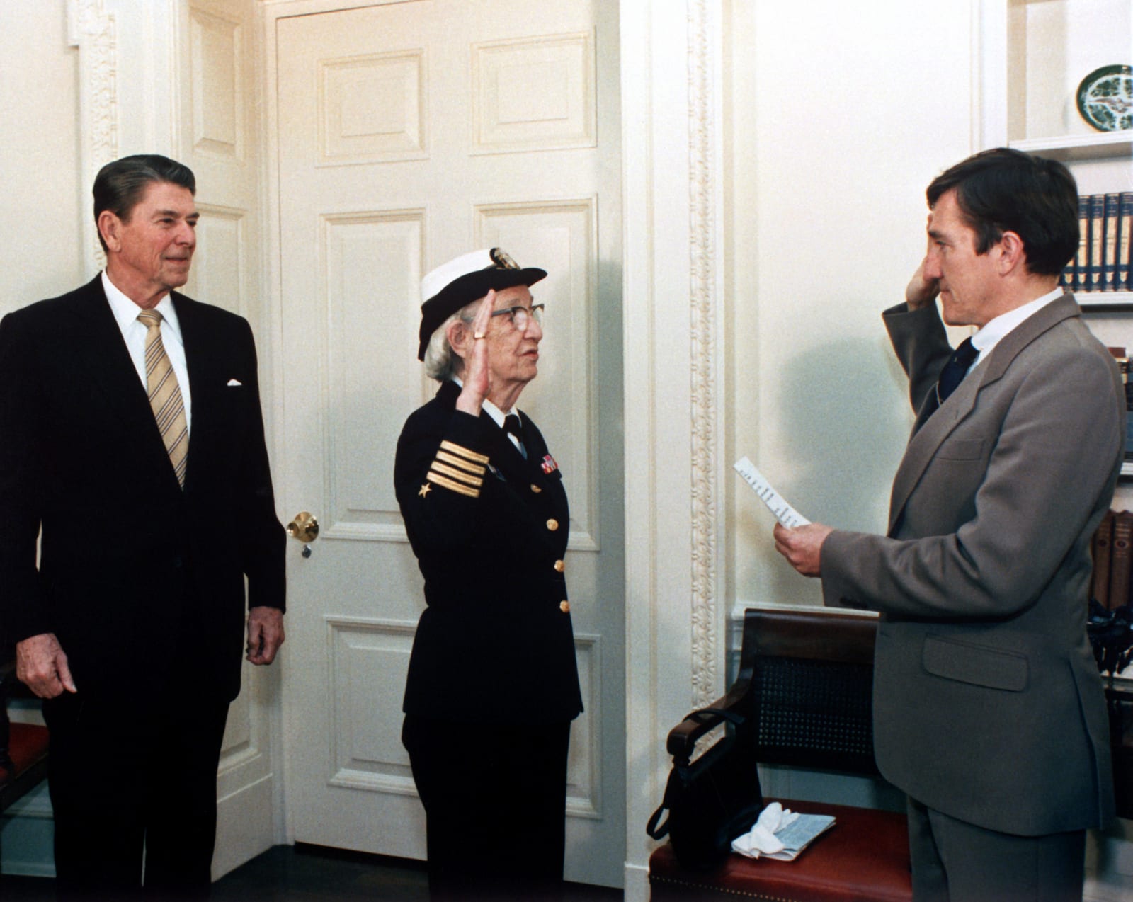 Portrait or photograph of Grace Hopper: Secretary of the Navy , John Lehman , right, promotes Capt. Grace Hopper to the rank of commodore in a ceremony at the W