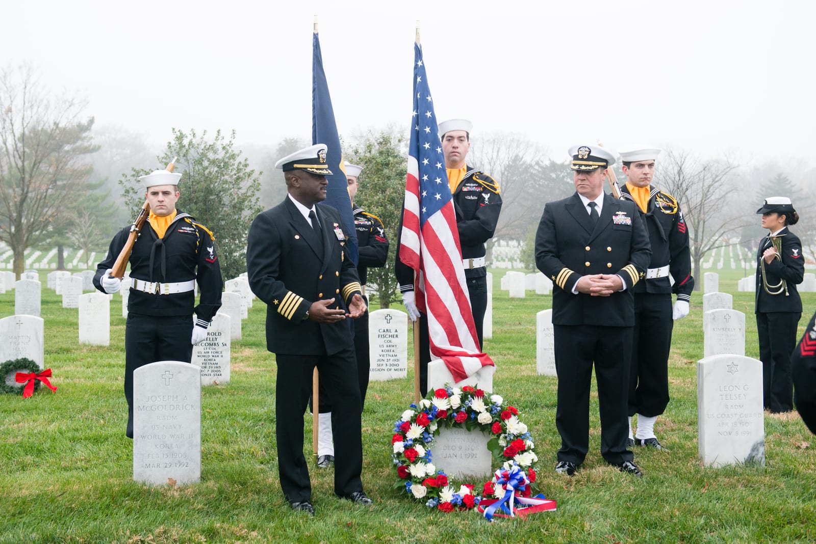 Portrait or photograph of Grace Hopper: Capt. Darryl Jackson, second left, commanding officer, Hopper Information Services Center, gives remarks during a ceremo