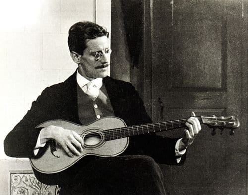 Portrait or photograph of James Joyce: James Joyce playing a guitar