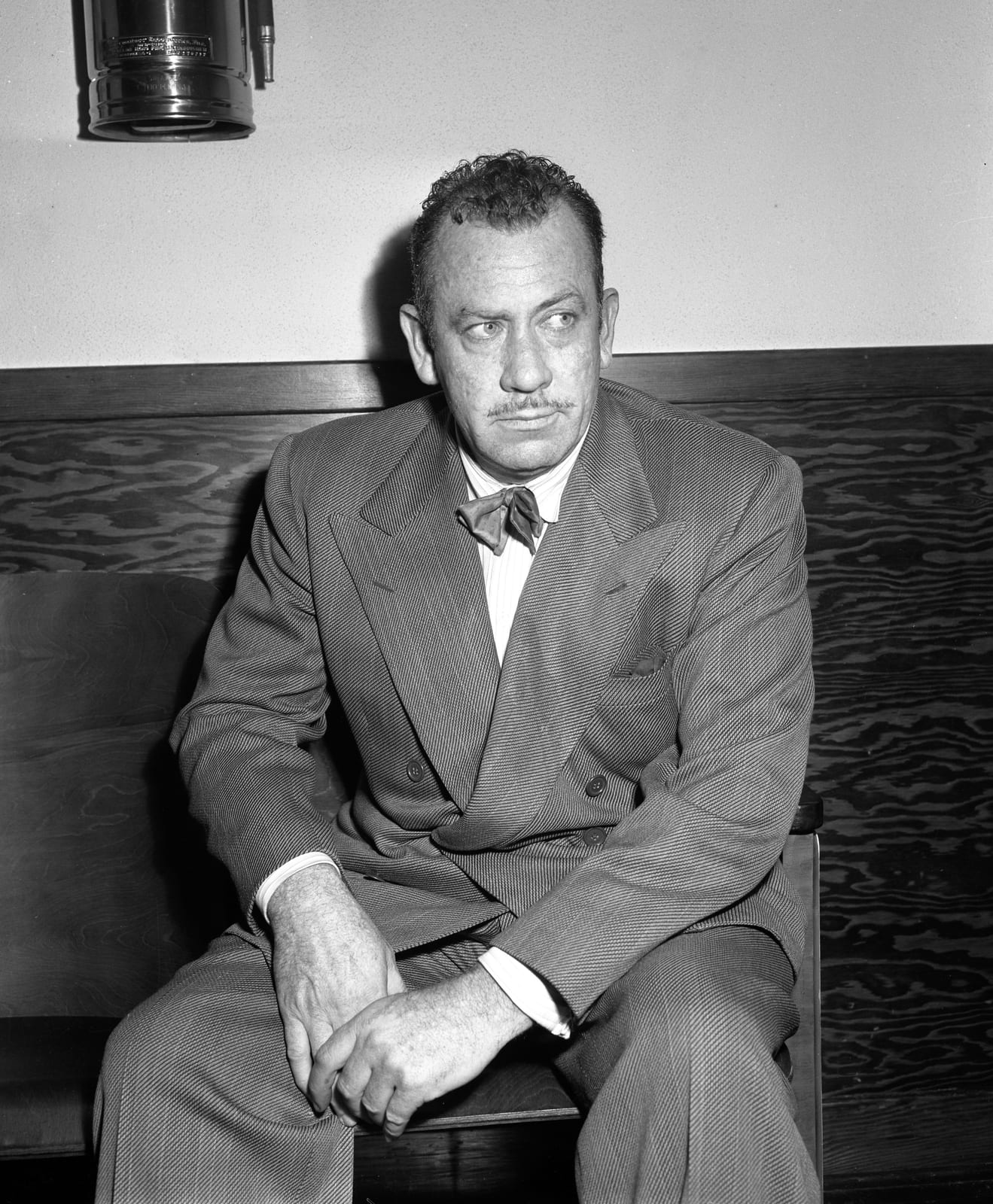 Portrait or photograph of John Steinbeck: John Steinbeck, seated portrait in a room