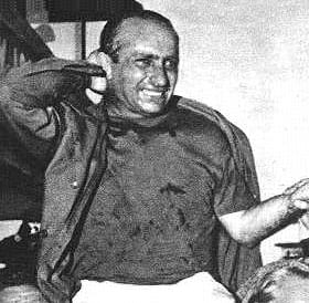 Portrait or photograph of Juan Manuel Fangio: Juan Manuel Fangio, llevado en andas luego de su triunfo en Nürburgring en el año 1957