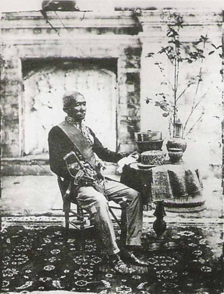 Portrait or photograph of King Mongkut: King Mongkut (Rama IV) of Siam (now Thailand). In this image, he wore a military uniform and sat on simple chair. The ph