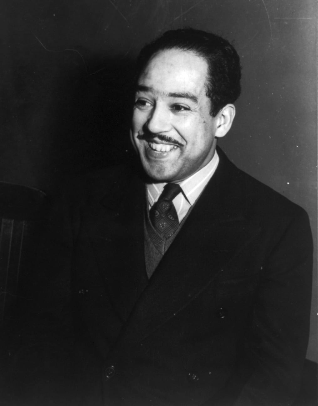 Portrait or photograph of Langston Hughes: Langston Hughes , half-length portrait, facing left. Farm Security Administration photo.