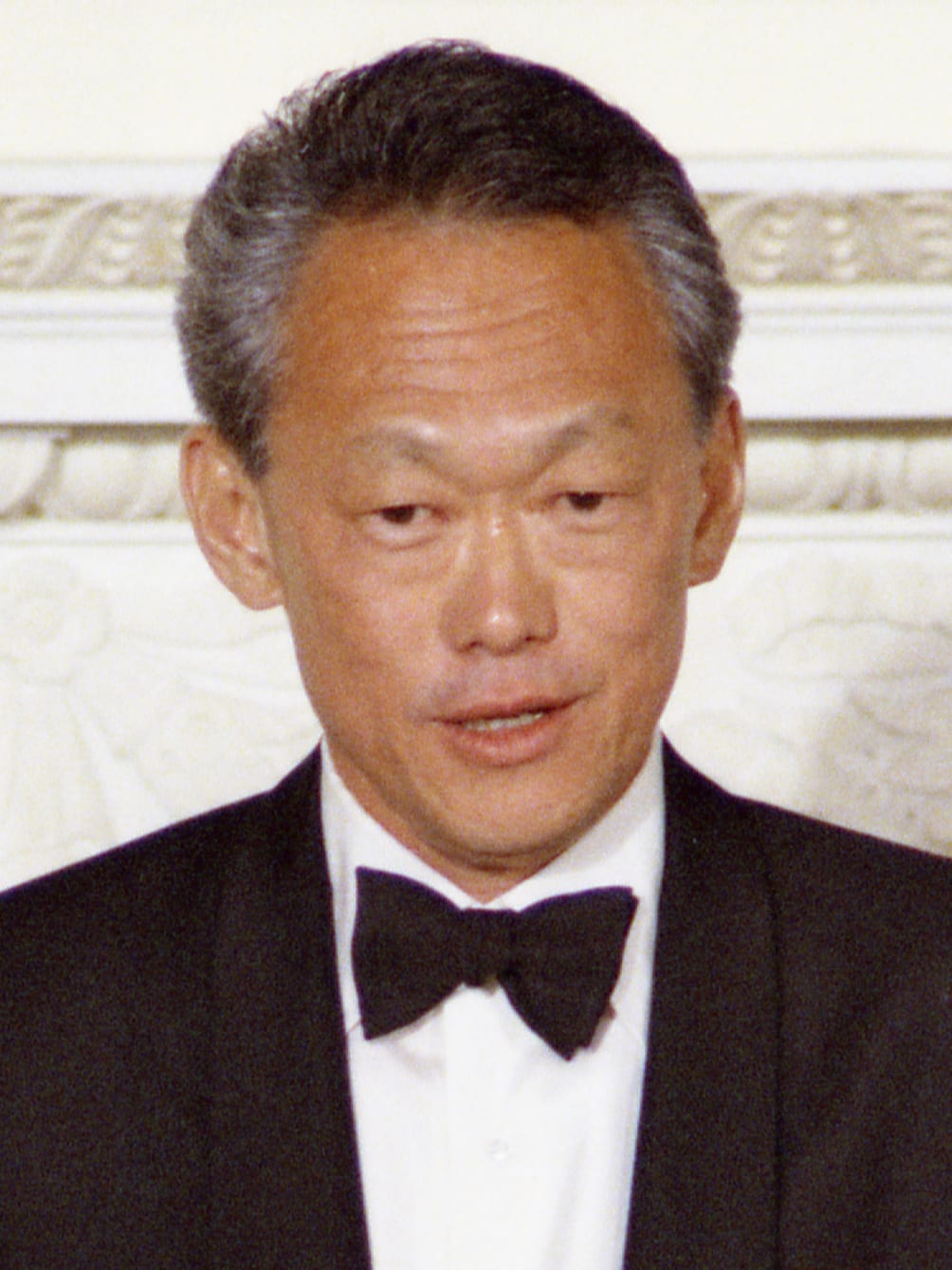 Portrait or photograph of Lee Kuan Yew: 1975, May 8– State Dining Room – The White House – Washington, DC – Lee Kuan Yew – standing, making a toast; formal wear
