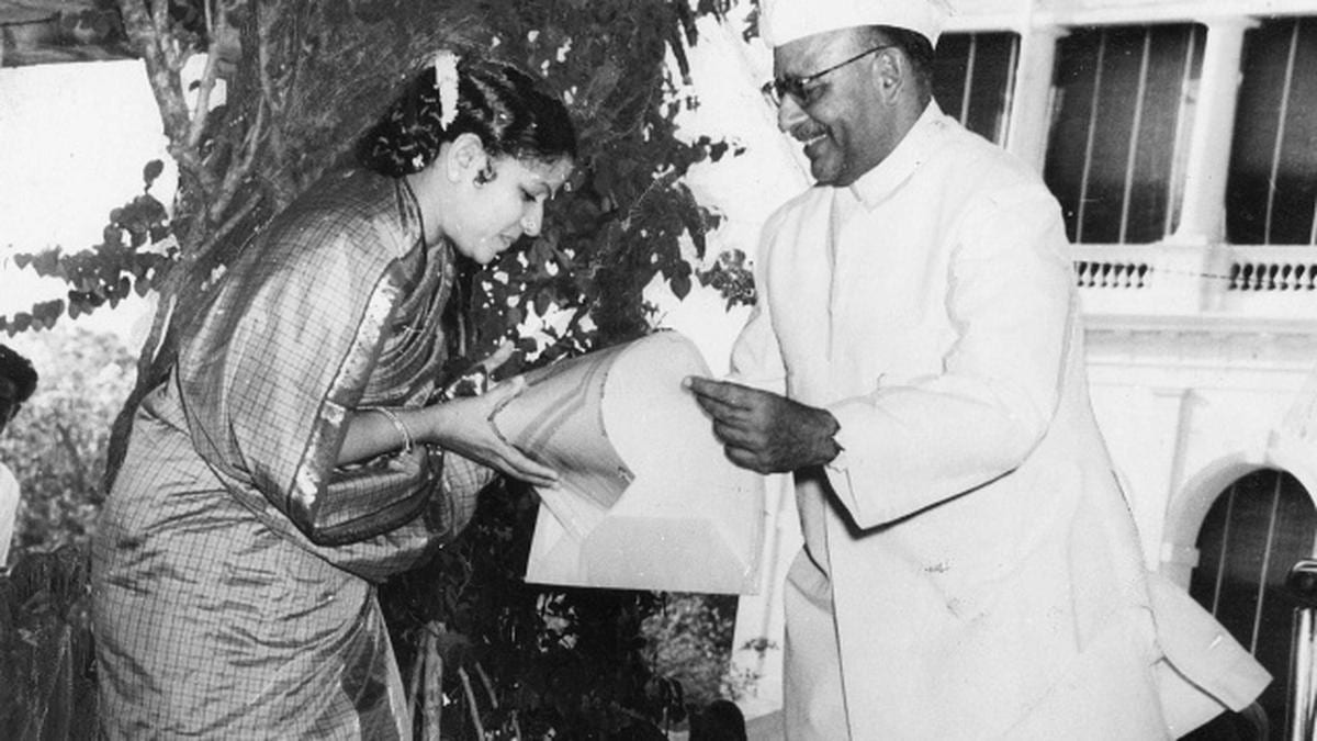 Portrait or photograph of M. S. Subbulakshmi: M. S. Subbulakshmi being awarded by Governor of Madras, Sri Prakasa, in March 1955 at an event in Raj Bhavan