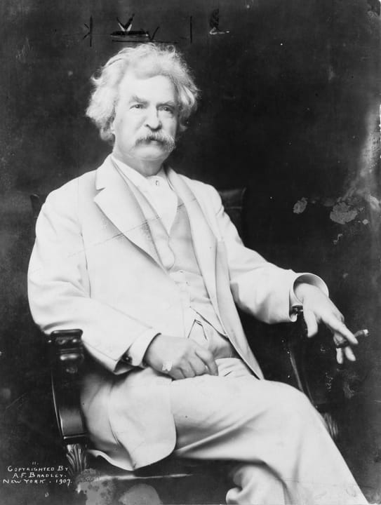 Portrait or photograph of Mark Twain: Mark Twain, three-quarter length portrait, seated, facing slightly right, with cigar in hand.