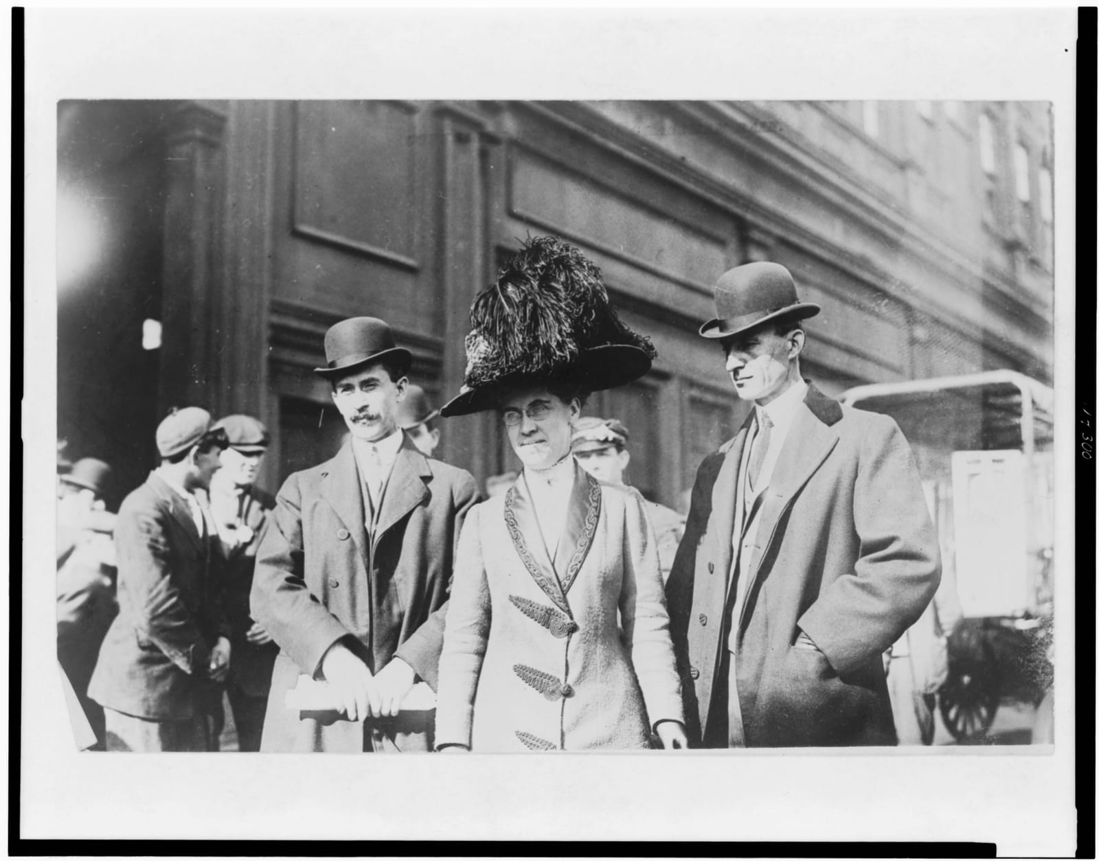 Portrait or photograph of Orville Wright: Title: Orville Wright, William Wright, and Katharine Wright, half-length portraits, standing outdoors Abstract/medium: