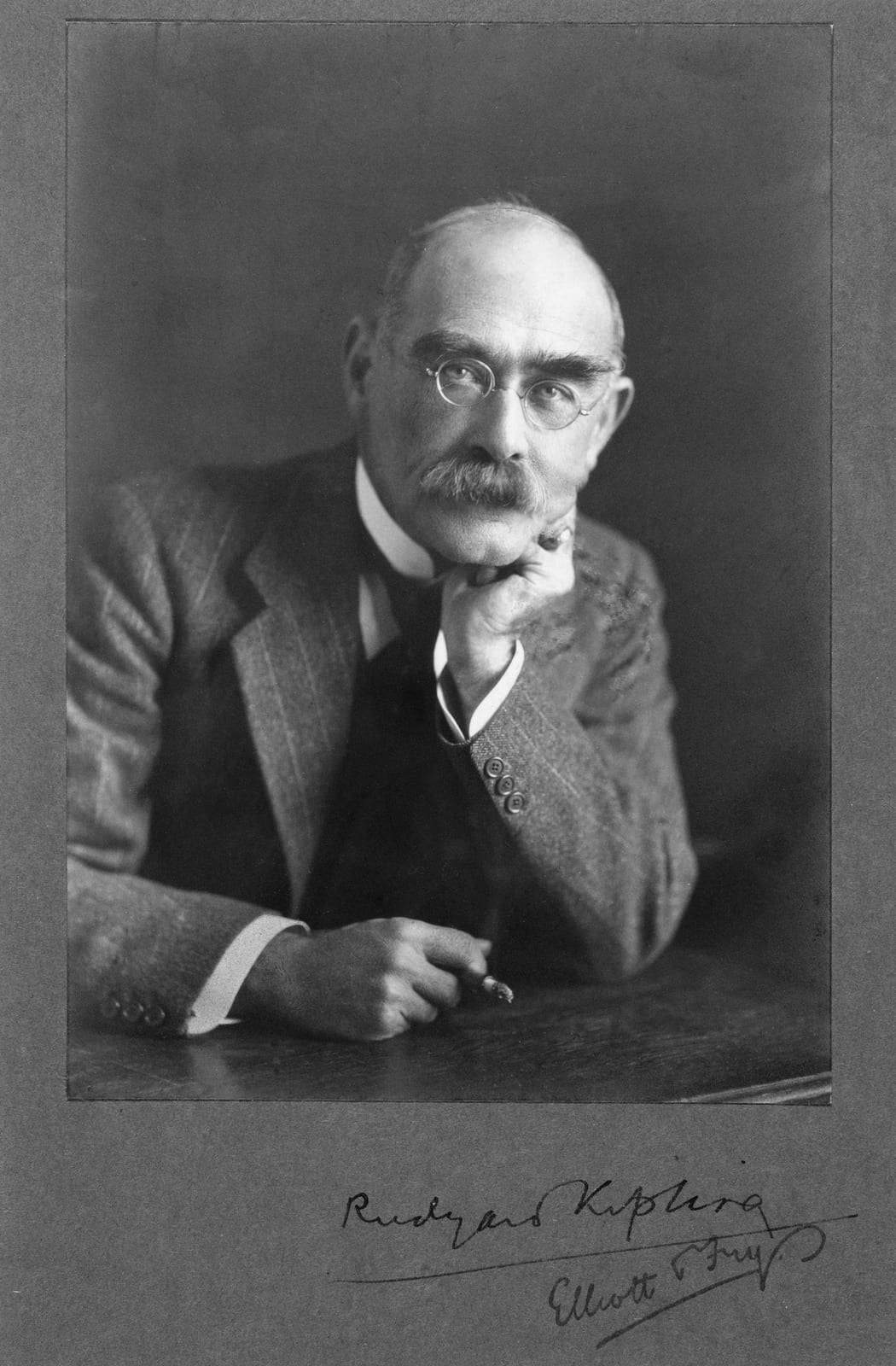 Portrait or photograph of Rudyard Kipling: Rudyard Kipling (1865-1936) silver print 19 x 14 cm signed: Rudyard Kipling signed: Elliott & Fry