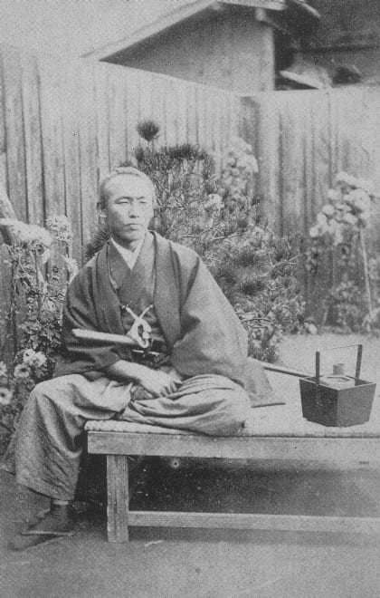 Portrait or photograph of Sakamoto Ryoma: Sakamoto Ryoma sitting statue chicken egg paper