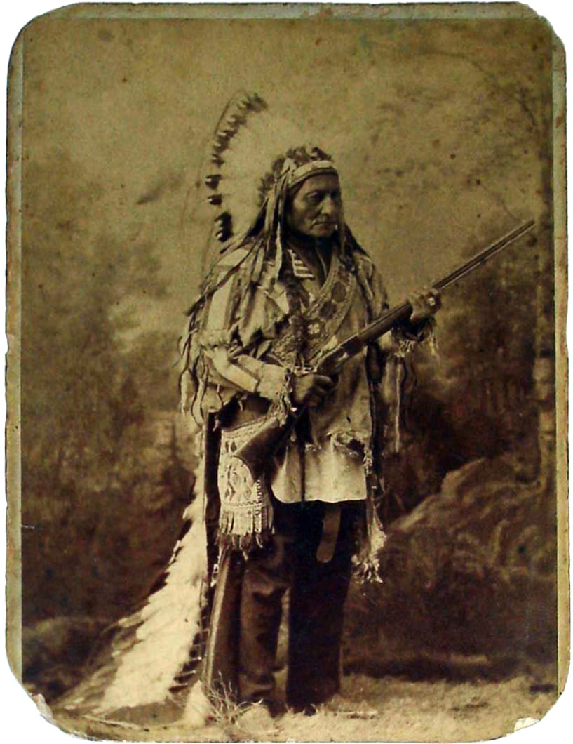 Portrait or photograph of Sitting Bull: Sitting Bull holding a Winchester lever-action carbine probably identical to the rifle that he surrendered, taken during
