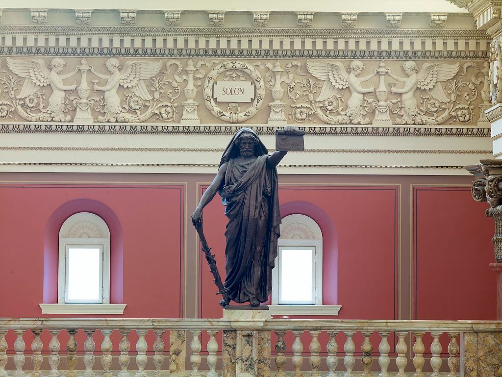 Portrait or photograph of Solon: Main Reading Room. Portrait statue of Solon along the balustrade. Library of Congress Thomas Jefferson Building, Washington, D.