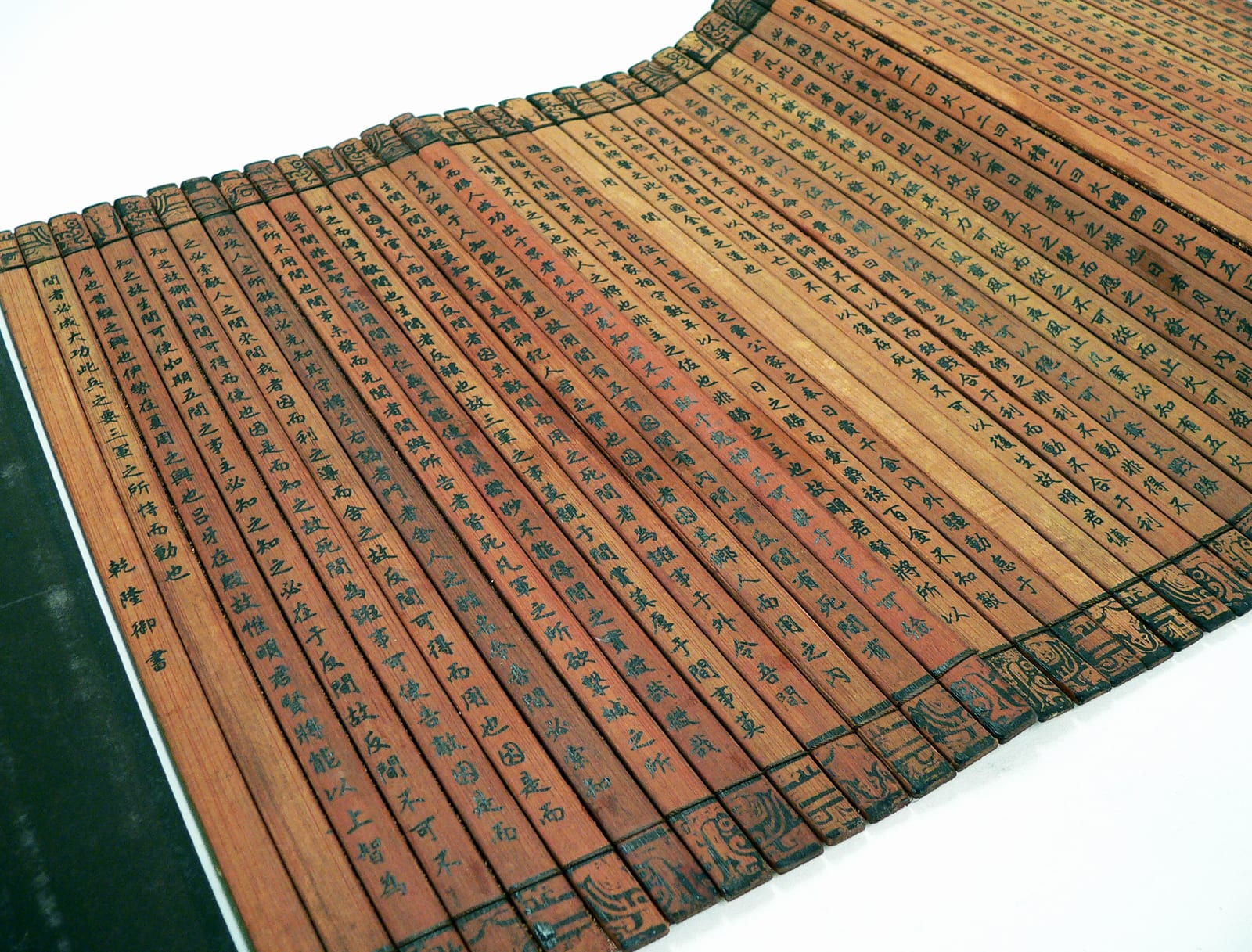 Portrait or photograph of Sun Tzu: A Chinese bamboo book, open and unfolded to display the contents. This copy of The Art of War (on the cover, "孫子兵法") by Sun T