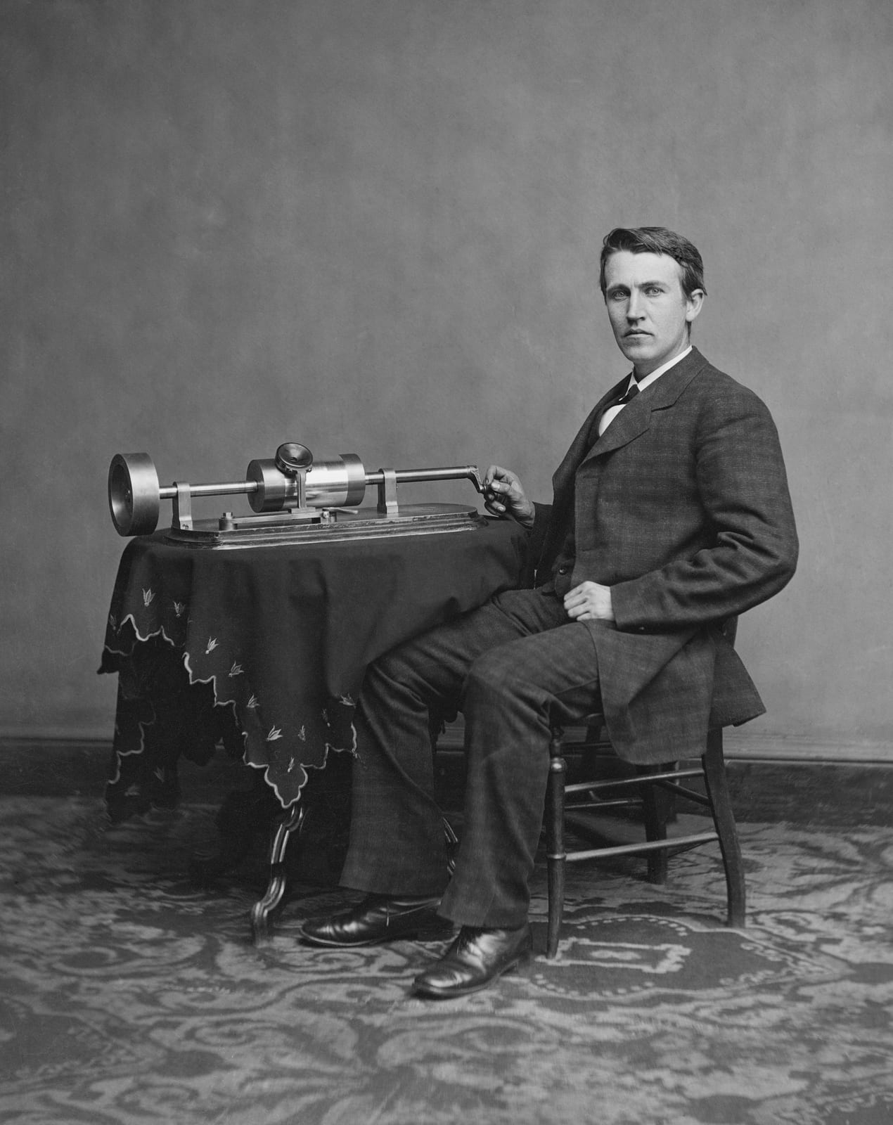 Portrait or photograph of Thomas Edison: Thomas Edison and his early phonograph. Cropped from U.S.A. Library of Congress copy. Edited Version. Dust removed by A