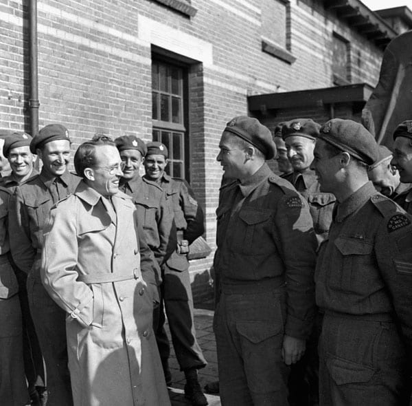 Portrait or photograph of Tommy Douglas: Hon. Tommy Douglas, Premier of Saskatchewan, talking with Private P. Campbell of The Saskatoon Light Infantry (M.G.), B