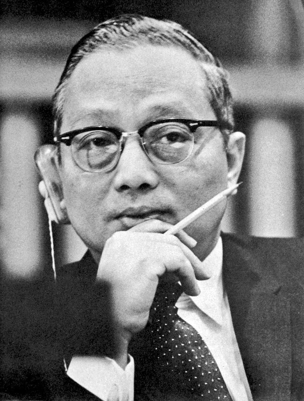 Portrait or photograph of U Thant: U Thant tunes in on the English translation at a UN Headquarters press conference