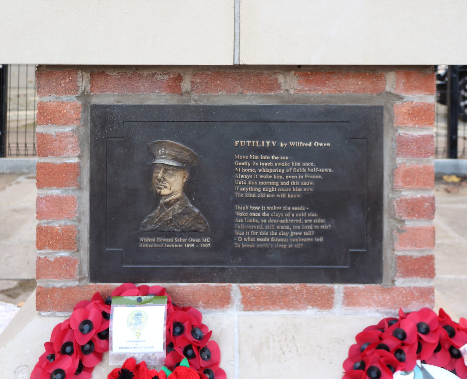 Portrait or photograph of Wilfred Owen: Metal panel featuring an embossed portrait of Wilfred Owen and the text of one of his poems, "Futility".