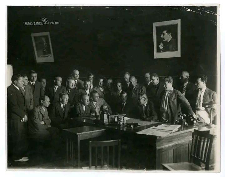 Portrait or photograph of Yakub Kolas: Belarusian & Georgian writers with the 1st Secretary of the Communist Party of Belarus Mykola Hikala in his office (1