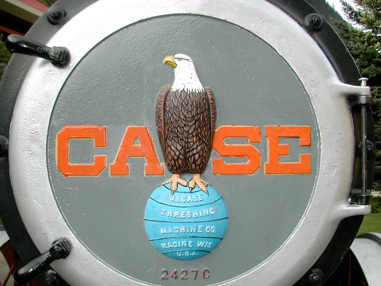 Photograph or image of Old Abe: Emblem of the J.I. Case Company on the door of the boiler of a Case steam engine. Said to be chosen after the mascot of the 8th