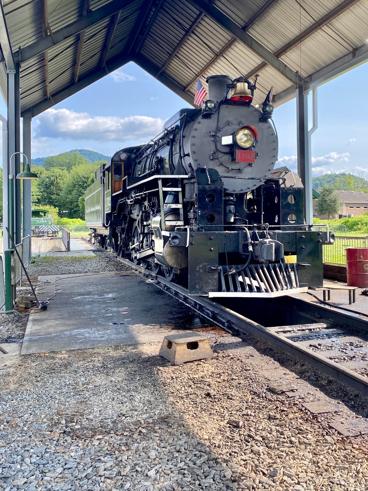 Photograph or image of Smoky: Great Smoky Mountains Railroad 1702 is an S160 class 2-8-0 "Consolidation" type steam locomotive built in September 1942 by the Ba