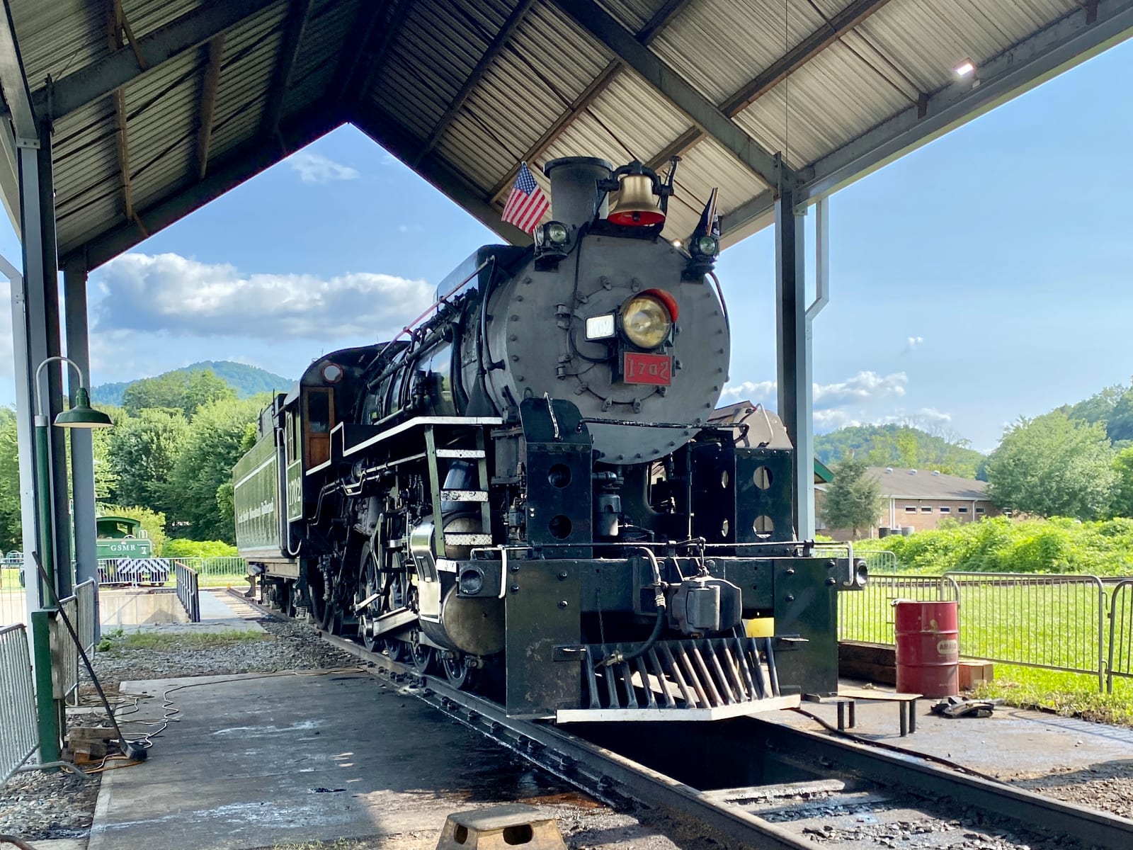 Photograph or image of Smoky: Great Smoky Mountains Railroad 1702 is an S160 class 2-8-0 "Consolidation" type steam locomotive built in September 1942 by the Ba